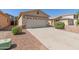 Well-maintained single-story home with desert landscaping, large driveway, and a two car garage at 857 E Impreria St, San Tan Valley, AZ 85140