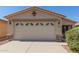 Charming single-story home featuring a large garage, desert landscaping, and a well-maintained front yard at 857 E Impreria St, San Tan Valley, AZ 85140