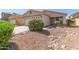Charming home with desert landscaping, stone accents, and a well-manicured lawn at 857 E Impreria St, San Tan Valley, AZ 85140