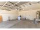 Spacious two-car garage with overhead lighting, built-in shelves, and concrete flooring at 857 E Impreria St, San Tan Valley, AZ 85140