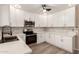 Modern kitchen boasts white cabinets, stainless steel appliances, sleek countertops, and stylish backsplash at 857 E Impreria St, San Tan Valley, AZ 85140
