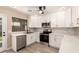 Modern kitchen features stainless steel appliances, quartz countertops, and white cabinets at 857 E Impreria St, San Tan Valley, AZ 85140