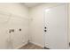 Functional laundry room with built-in shelving and wood look floors at 857 E Impreria St, San Tan Valley, AZ 85140