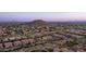 Scenic aerial view of a neighborhood nestled in a desert landscape, offering breathtaking views of mountains at 9037 E Indigo St, Mesa, AZ 85207