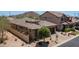 Aerial view of a tan home showcasing a tile roof and desert landscaping at 9037 E Indigo St, Mesa, AZ 85207