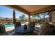 Outdoor living area with patio seating, overlooking a backyard swimming pool and desert landscape at 9037 E Indigo St, Mesa, AZ 85207
