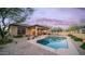 Inviting backyard oasis featuring a sparkling pool, covered patio, and desert landscaping, perfect for relaxation at 9037 E Indigo St, Mesa, AZ 85207