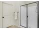 Bright bathroom featuring a glass enclosed shower, door to bathroom, and towel rack at 9037 E Indigo St, Mesa, AZ 85207