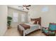 Inviting bedroom featuring natural light, tile floors, chair, and a comfortable wood-framed bed at 9037 E Indigo St, Mesa, AZ 85207