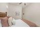 Comfortable bedroom features a wood headboard and neutral color scheme with comfortable pillows at 9037 E Indigo St, Mesa, AZ 85207