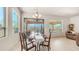 Cozy dining area featuring a chandelier and sliding door access to the covered patio and backyard pool at 9037 E Indigo St, Mesa, AZ 85207