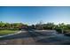 Gated community entrance with brick-paved road and desert landscaping providing privacy and exclusivity at 9037 E Indigo St, Mesa, AZ 85207