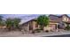 Tan home exterior displaying desert landscaping with native trees and cacti at 9037 E Indigo St, Mesa, AZ 85207