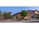 Charming home exterior featuring desert landscaping, a two-car garage, and a well-maintained facade at 9037 E Indigo St, Mesa, AZ 85207