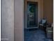 A charming front entry features a decorative door and cozy seating area with outdoor furniture at 9037 E Indigo St, Mesa, AZ 85207