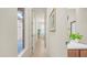 Inviting hallway with natural light, tile flooring, and access to various rooms in the home at 9037 E Indigo St, Mesa, AZ 85207