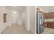 Open-concept kitchen with stainless steel appliances, wood cabinetry, and tiled floors at 9037 E Indigo St, Mesa, AZ 85207