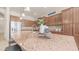 Close-up of the kitchen island featuring granite countertops, bar stool seating, and modern decor at 9037 E Indigo St, Mesa, AZ 85207