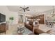 Open concept living room featuring a leather sofa, view of the kitchen and dining area, and ceiling fan at 9037 E Indigo St, Mesa, AZ 85207
