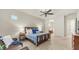 Relaxing main bedroom with a sitting area, ceiling fan, and view into the main bathroom at 9037 E Indigo St, Mesa, AZ 85207