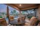 Covered patio featuring an umbrella, comfortable seating, overlooking a pool and desert landscaping at 9037 E Indigo St, Mesa, AZ 85207