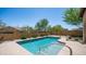 Backyard pool surrounded by desert landscaping, block fencing, and clear blue skies create a private oasis at 9037 E Indigo St, Mesa, AZ 85207