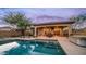 Inviting pool with a covered patio and outdoor seating area is perfect for entertaining and relaxation at 9037 E Indigo St, Mesa, AZ 85207