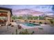 Inviting backyard oasis with a sparkling pool and hot tub, perfect for relaxation and entertaining in style at 9037 E Indigo St, Mesa, AZ 85207