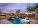Relaxing backyard pool with desert landscaping, offering a private outdoor oasis for leisure and recreation at 9037 E Indigo St, Mesa, AZ 85207