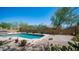 Private backyard pool and hot tub with desert landscaping, and brick patio, perfect for relaxation at 9037 E Indigo St, Mesa, AZ 85207