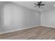 Open bedroom space with wood-look floors, recessed lighting, and a ceiling fan for comfortable living at Xxxx S Hunt Hwy, Queen Creek, AZ 85142