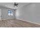 Spacious bedroom featuring wood-look floors, a ceiling fan, recessed lighting, and a large window at Xxxx S Hunt Hwy, Queen Creek, AZ 85142