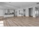 Open-concept living room boasts a spacious layout and a kitchen with sleek, modern design and beautiful flooring at Xxxx S Hunt Hwy, Queen Creek, AZ 85142