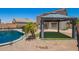 Backyard featuring pool with safety fence, new gazebo on artificial turf and desert landscape at 11020 N 154Th Ln, Surprise, AZ 85379