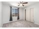 Bedroom with carpet, window, ceiling fan and sliding closet doors at 11020 N 154Th Ln, Surprise, AZ 85379