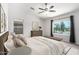Bright bedroom featuring a ceiling fan, natural light, and stylish decor, perfect for relaxation and comfort at 11020 N 154Th Ln, Surprise, AZ 85379