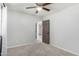 Simple bedroom featuring plush carpet, neutral walls and brown door leading to adjacent room at 11020 N 154Th Ln, Surprise, AZ 85379