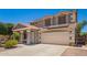 Two-story home featuring a desert-landscaped front yard and a two-car garage at 11020 N 154Th Ln, Surprise, AZ 85379