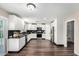 Stylish kitchen with white cabinets, modern appliances, and a black backsplash at 11020 N 154Th Ln, Surprise, AZ 85379