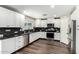 Beautiful renovated kitchen boasts white cabinets, backsplash and stainless appliances at 11020 N 154Th Ln, Surprise, AZ 85379