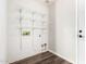 Laundry room boasts wood-look floors and white wire shelving for storage at 11020 N 154Th Ln, Surprise, AZ 85379