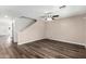Bright living room featuring stylish wood flooring and a modern ceiling fan at 11020 N 154Th Ln, Surprise, AZ 85379