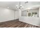 Spacious living room with hardwood floors and modern light fixture at 11020 N 154Th Ln, Surprise, AZ 85379