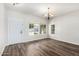 Bright living room featuring wood floors and multiple windows for natural light at 11020 N 154Th Ln, Surprise, AZ 85379