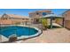 Backyard view of a refreshing pool with a gazebo and secure safety fence at 11020 N 154Th Ln, Surprise, AZ 85379
