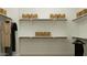 Organized walk-in closet offers ample storage space with multiple shelves and hanging rods with decorative basket storage at 11986 W Calle De Pompas --, Peoria, AZ 85383