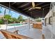 Spacious covered patio featuring swings, offering a relaxing outdoor living space with views of the pool and lush backyard at 12835 N 78Th St, Scottsdale, AZ 85260