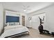 Well-lit bedroom with a murphy bed, ceiling fan, and exercise equipment at 12835 N 78Th St, Scottsdale, AZ 85260