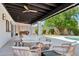Relaxing covered patio with a fire pit and comfortable seating, perfect for outdoor gatherings and cozy evenings at 12835 N 78Th St, Scottsdale, AZ 85260