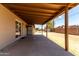 Inviting covered back patio with spacious concrete and block wall, great for outdoor entertaining at 1545 W 7Th Ave, Mesa, AZ 85202